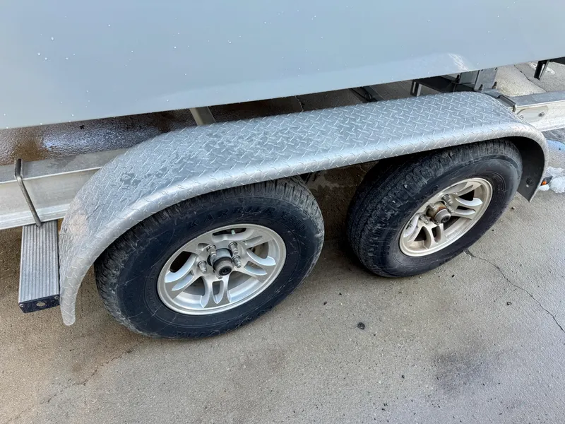 Slide: The Image of Trailer wheels of a 2020 Parker 2300 Special Edition boat on concrete surface. - 23