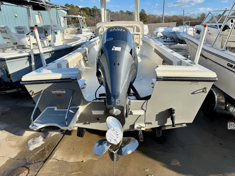 Slide: The Image of 2020 Parker 2300 Special Edition boat with outboard motor, docked in a marina. - 5