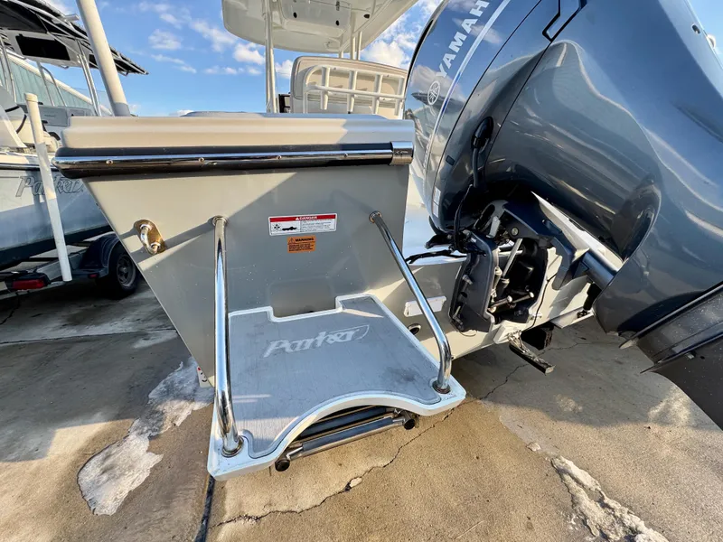Slide: The Image of 2020 Parker 2300 Special Edition boat with Yamaha engine, featuring a swim platform and ladder. - 6