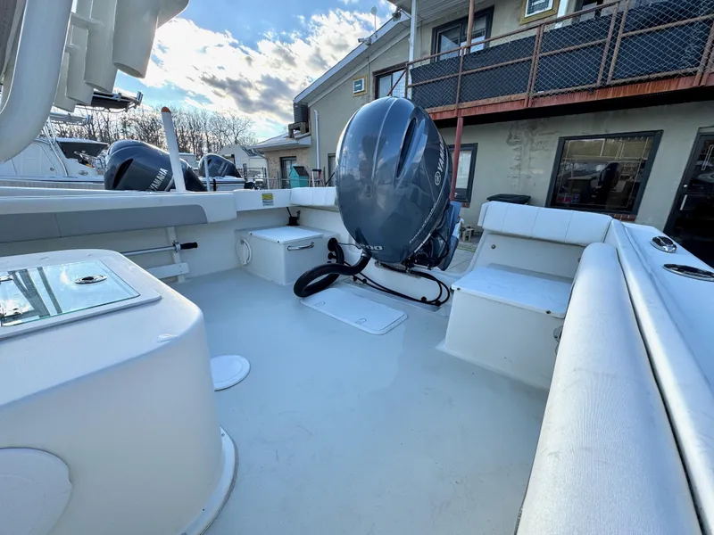 Slide: The Image of 2020 Parker 2300 Special Edition boat with outboard motor, docked near a building. - 7