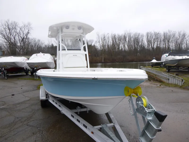 Slide: The Image of 2025 Sea Pro 250 Bay boat on trailer under clear blue sky. - 1