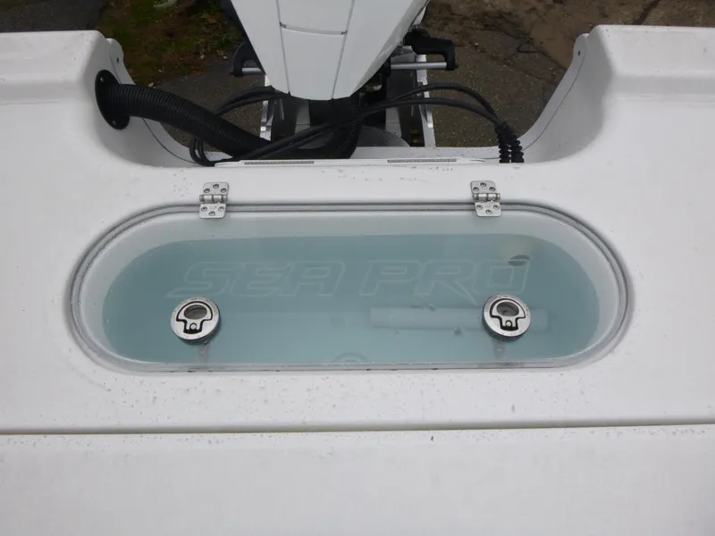 Slide: The Image of 2025 Sea Pro 250 Bay boat console with steering wheel, gauges, and cup holders. - 10