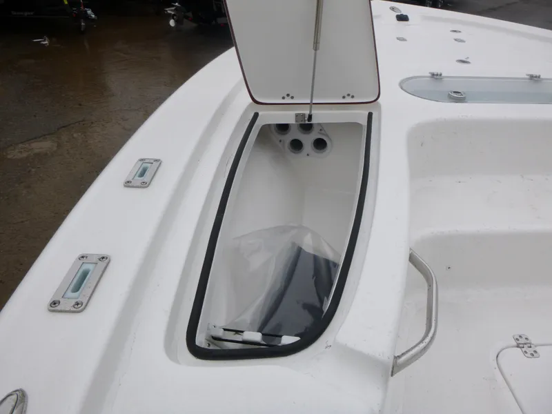 Slide: The Image of 2025 Sea Pro 250 Bay boat storage compartment with open door. - 16