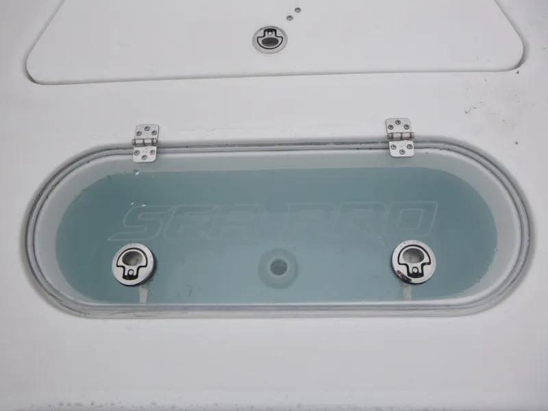 Slide: The Image of 2025 Sea Pro 250 Bay boat deck with storage compartments and seating. - 17