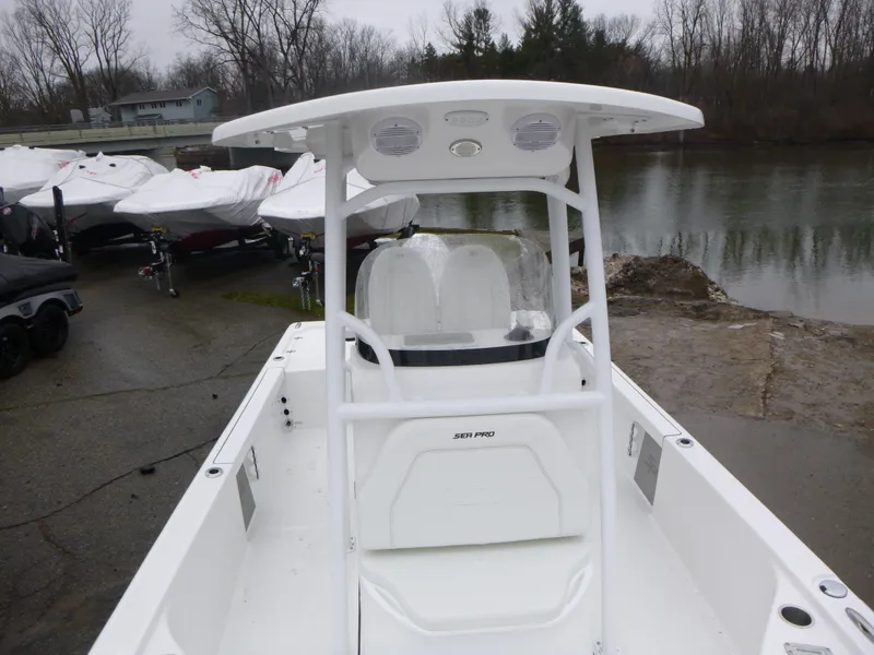 Slide: The Image of 2025 Sea Pro 250 Bay boat on trailer, parked outdoors under clear sky. - 5