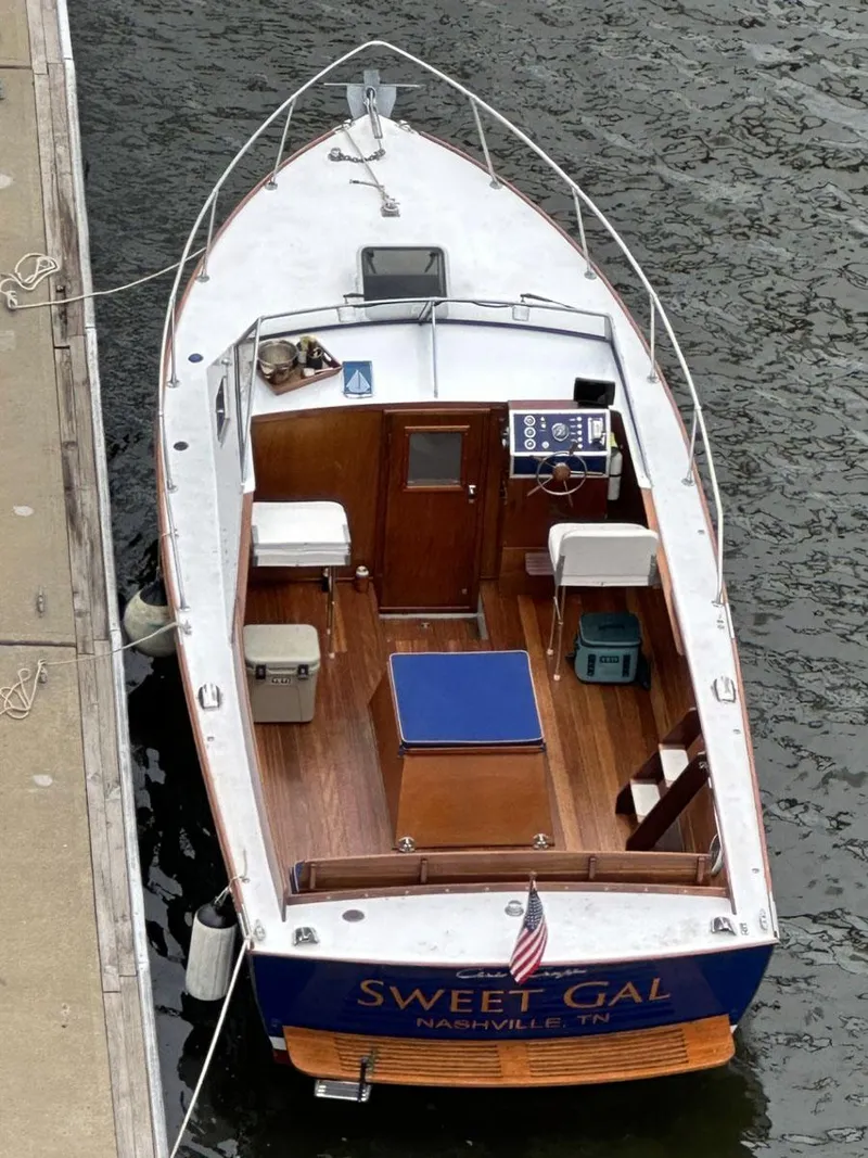 Slide: The Image of 1968 Chris-Craft Cavalier Cutlass 26 boat docked, named "Sweet Gal," with wooden deck and cabin. - 3