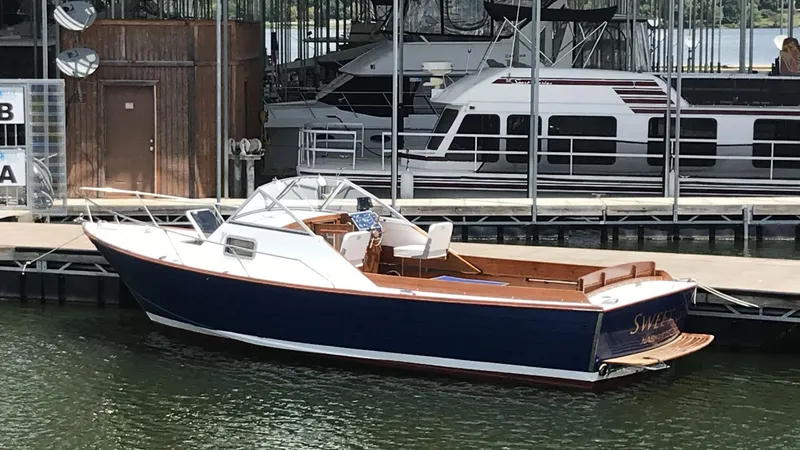 The Image of 1968 Chris-Craft Cavalier Cutlass 26 boat docked at a marina. - 0