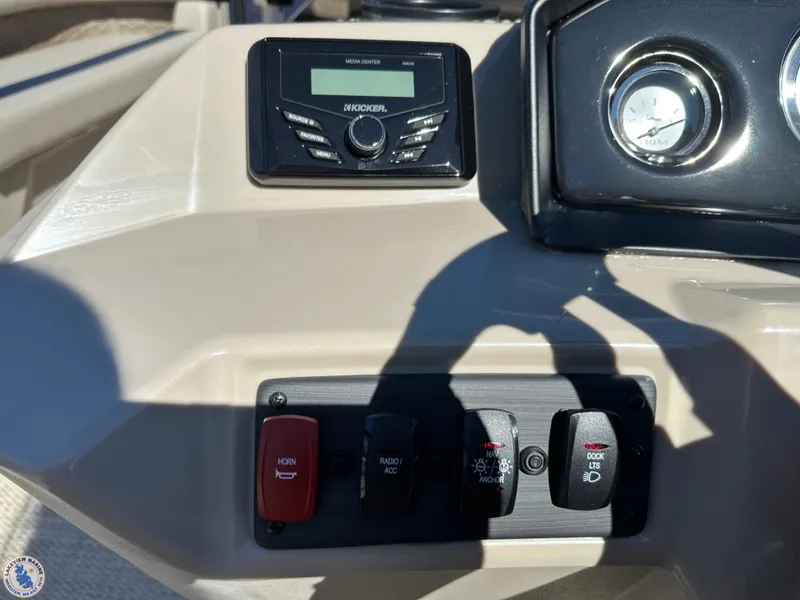 Slide: The Image of 2024 Bennington 22 SSR dashboard with Kicker stereo and control switches. - 4