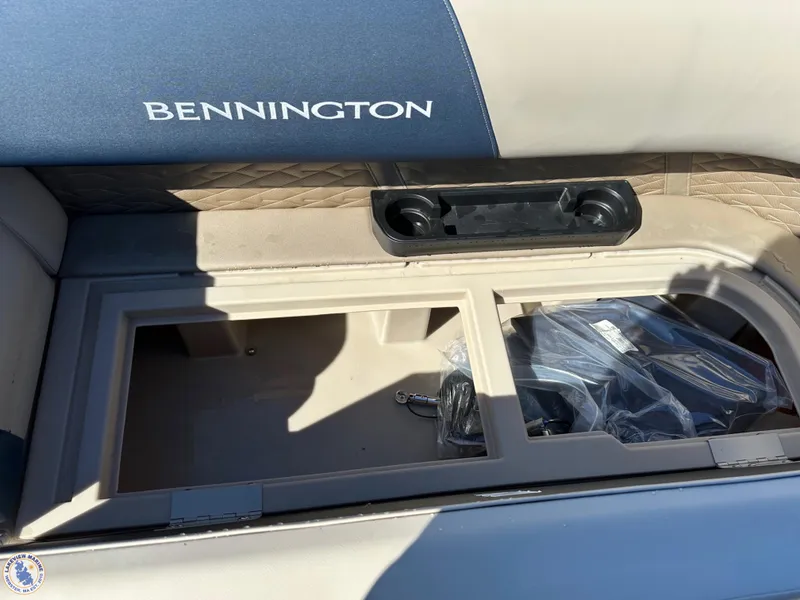 Slide: The Image of 2024 Bennington 22 SSR boat storage compartment with cup holders and accessories. - 7