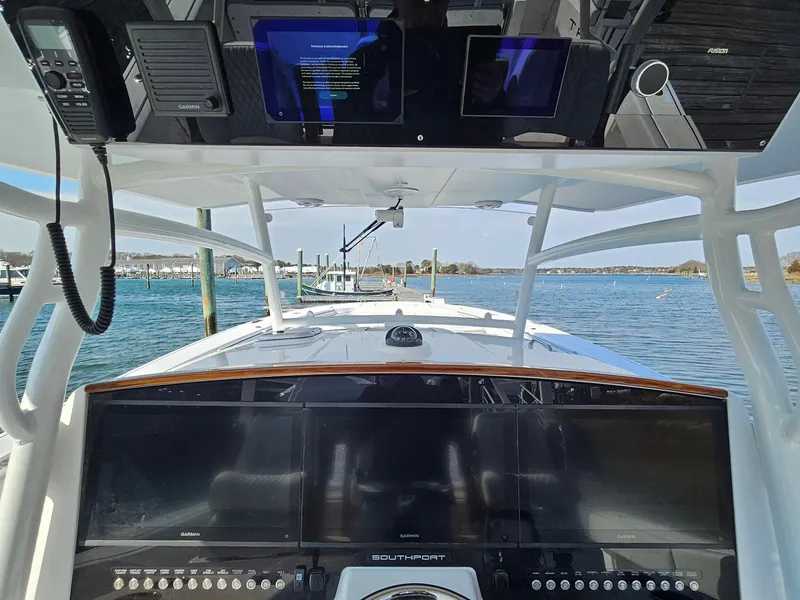 Slide: The Image of 2025 Southport 38 FE boat with triple Mercury engines on water. - 19