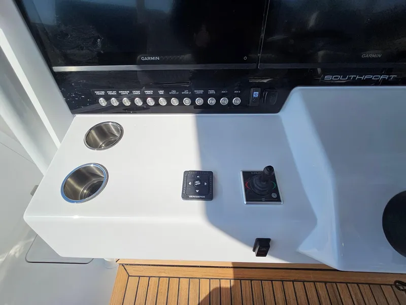 Slide: The Image of 2025 Southport 38 FE boat interior with luxurious seating and advanced dashboard. - 23