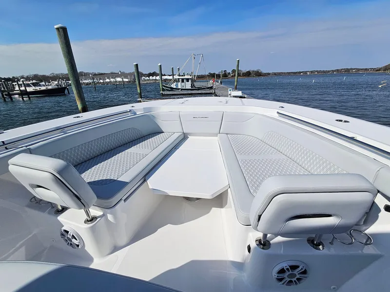 Slide: The Image of 2025 Southport 38 FE boat with open storage compartments by a dock. - 28