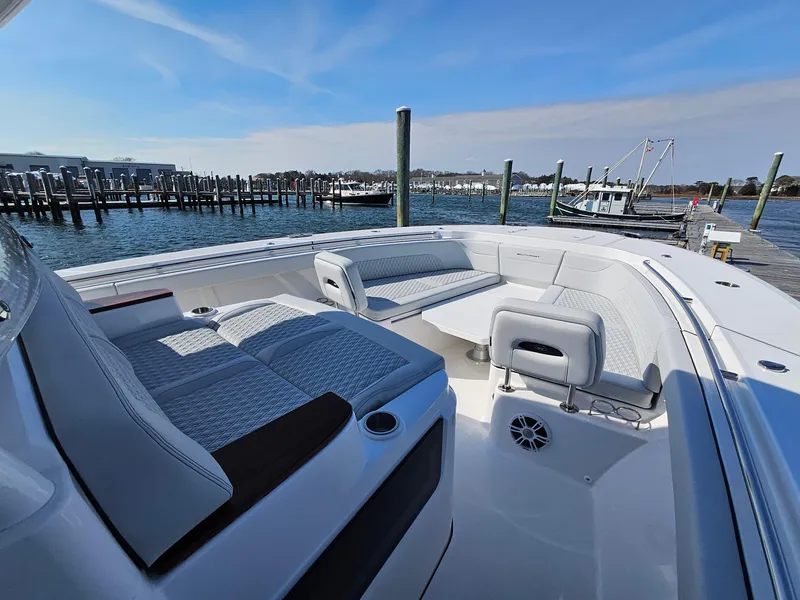 Slide: The Image of 2025 Southport 38 FE boat with open storage compartments and dual engines. - 29