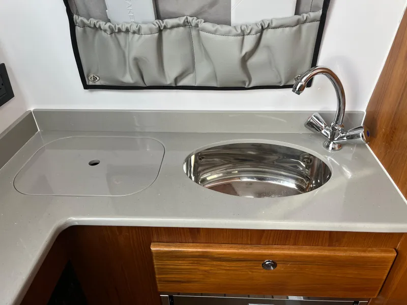 Slide: The Image of Open storage compartment on 2025 Southport 38 FE boat. - 32