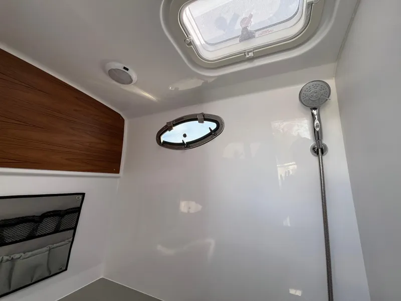 Slide: The Image of 2025 Southport 38 FE boat with elegant seating and sleek design on a sunny day. - 35