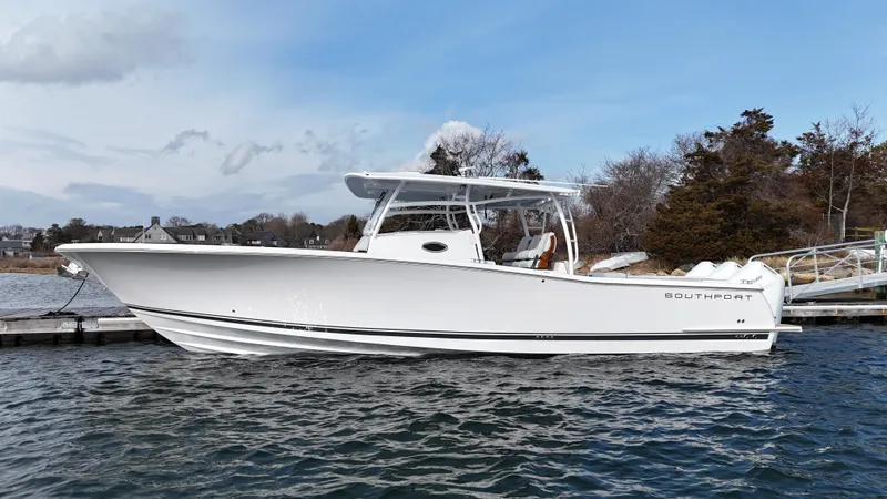 Slide: The Image of Luxurious seating on 2025 Southport 38 FE boat, featuring elegant wood accents and waterfront view. - 36
