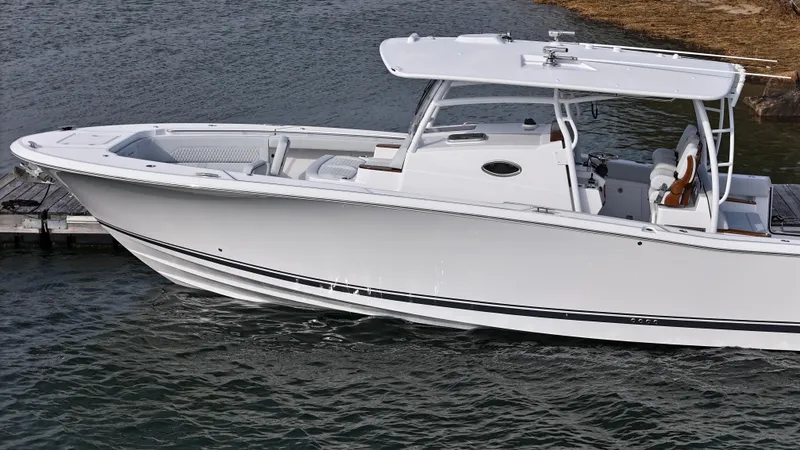 Slide: The Image of 2025 Southport 38 FE boat with elegant teak flooring and sleek white interior design. - 41