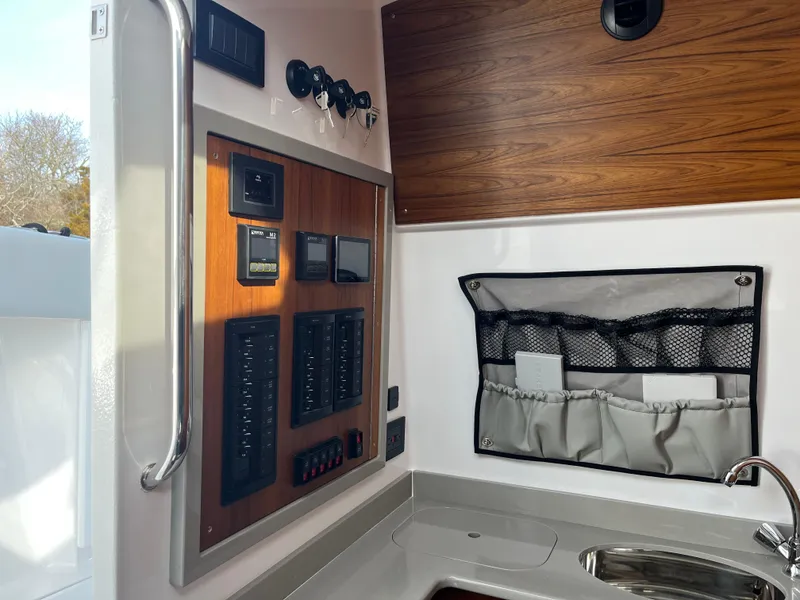 Slide: The Image of Electrical control panel on 2025 Southport 38 FE boat, featuring switches and digital displays. - 58