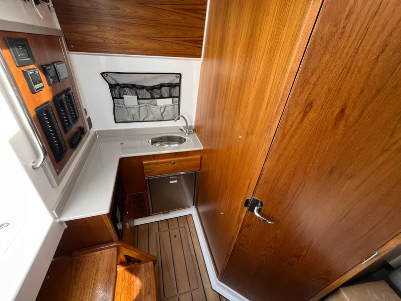 Slide: The Image of 2025 Southport 38 FE boat bathroom with toilet and shower area. - 61