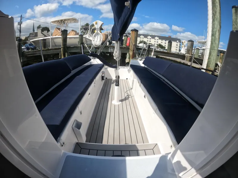 Slide: The Image of 2022 J Boats J/9 sailboat interior with blue seating and wooden deck. - 11