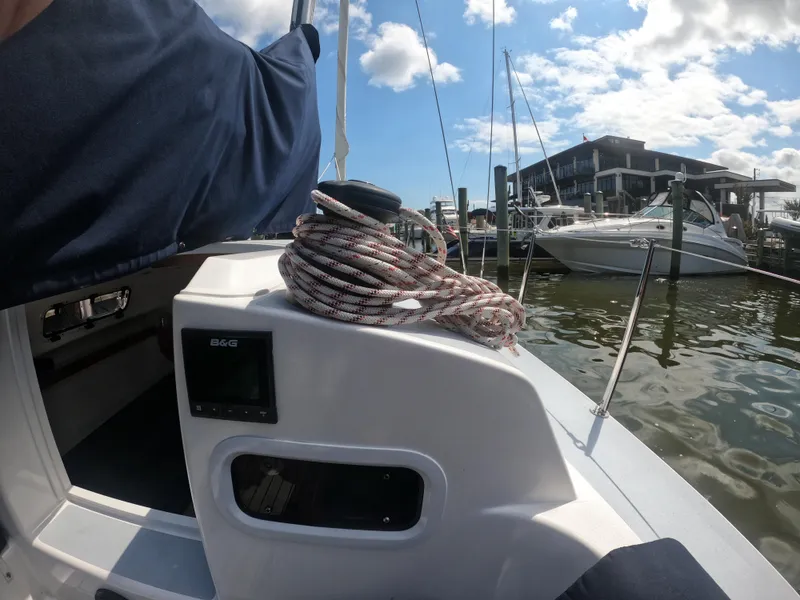 Slide: The Image of 2022 J Boats J/9 sailboat docked, featuring coiled rope and B&G equipment. - 12