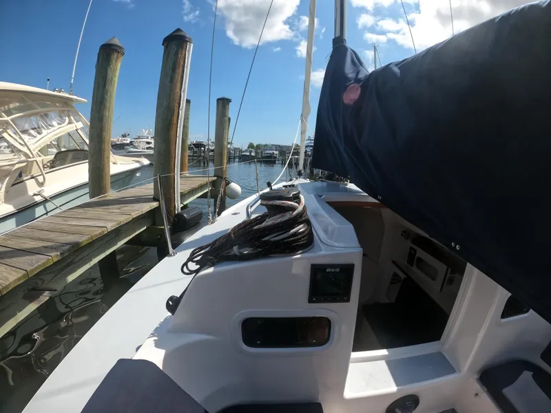 Slide: The Image of 2022 J Boats J/9 sailboat docked at marina under clear blue sky. - 13