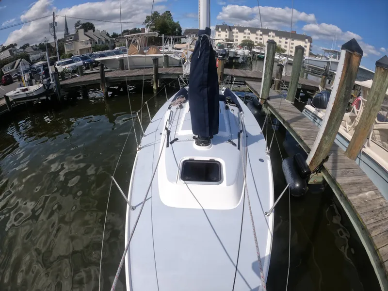 Slide: The Image of 2022 J Boats J/9 sailboat docked at a marina under a clear blue sky. - 15