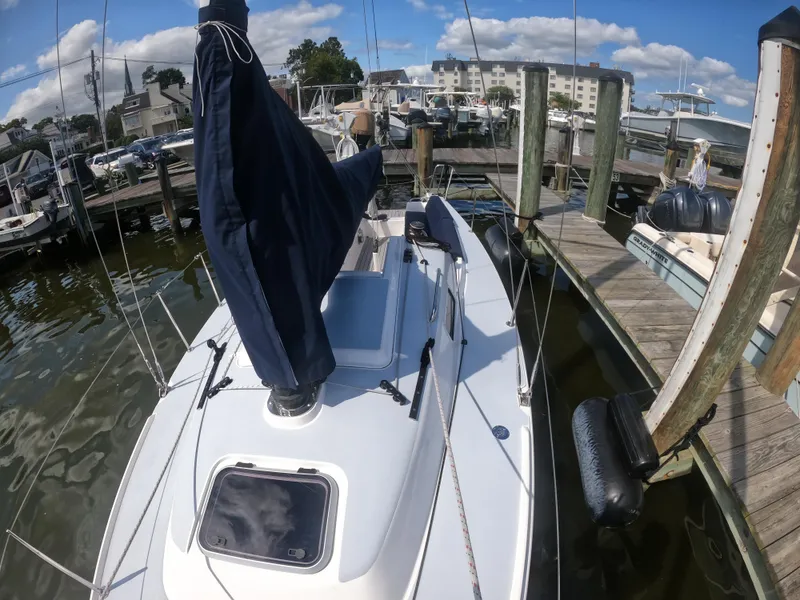 Slide: The Image of 2022 J Boats J/9 sailboat docked at a marina under a clear blue sky. - 16
