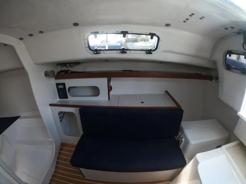 Slide: The Image of Interior of 2022 J Boats J/9 sailboat, featuring seating and storage compartments. - 21