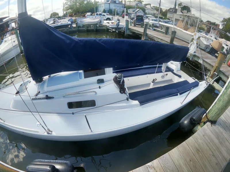 Slide: The Image of 2022 J Boats J/9 sailboat docked, featuring a sleek design and blue sail cover. - 3