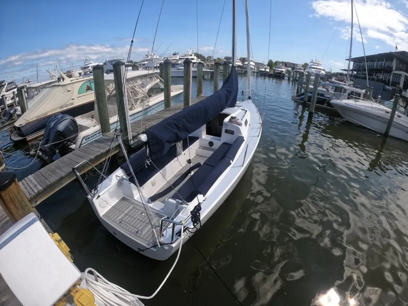 Slide: The Image of 2022 J Boats J/9 sailboat docked at a marina under a clear blue sky. - 4