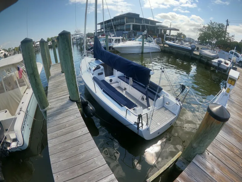 Slide: The Image of 2022 J Boats J/9 sailboat docked at a marina under a clear sky. - 5