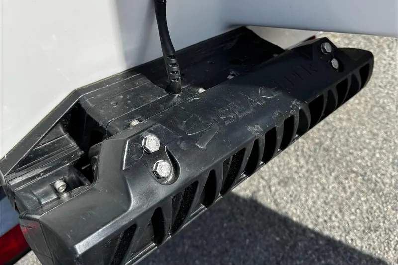 Slide: The Image of 2025 Tidewater 232 CC Adventure boat transom with black mounting bracket. - 10
