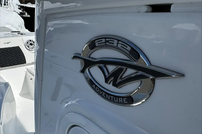Slide: The Image of 2025 Tidewater 232 CC Adventure boat emblem on white surface. - 12