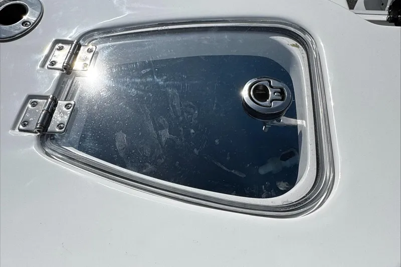 Slide: The Image of Hatch on 2025 Tidewater 232 CC Adventure boat, reflecting sunlight. - 15