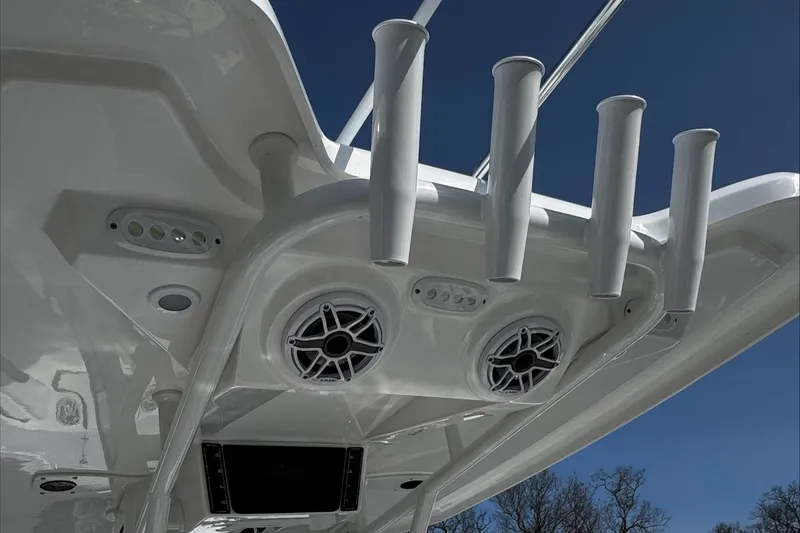 Slide: The Image of 2025 Tidewater 232 CC Adventure boat with rod holders and speakers on the T-top. - 23