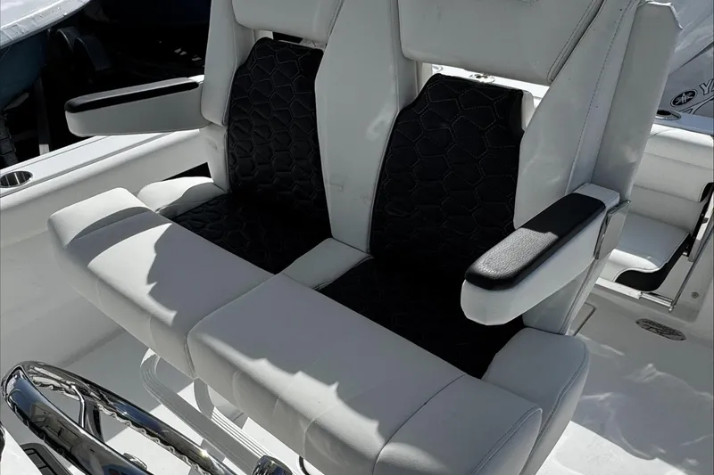 Slide: The Image of 2025 Tidewater 232 CC Adventure boat seats with black and white upholstery. - 24