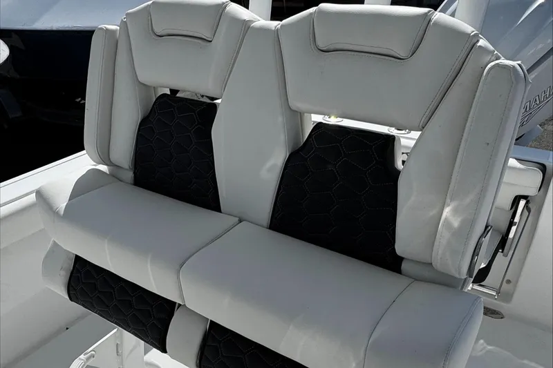 Slide: The Image of 2025 Tidewater 232 CC Adventure boat seats with white and black upholstery. - 25