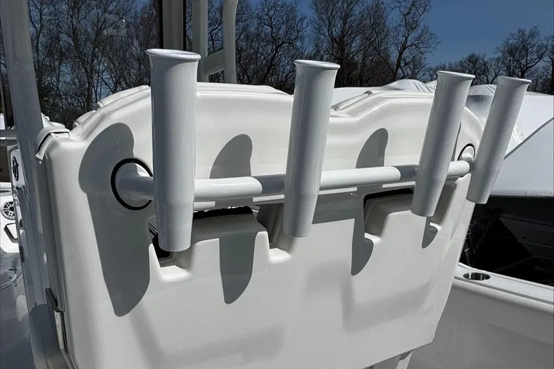Slide: The Image of 2025 Tidewater 232 CC Adventure boat rod holders, white, with trees in the background. - 26