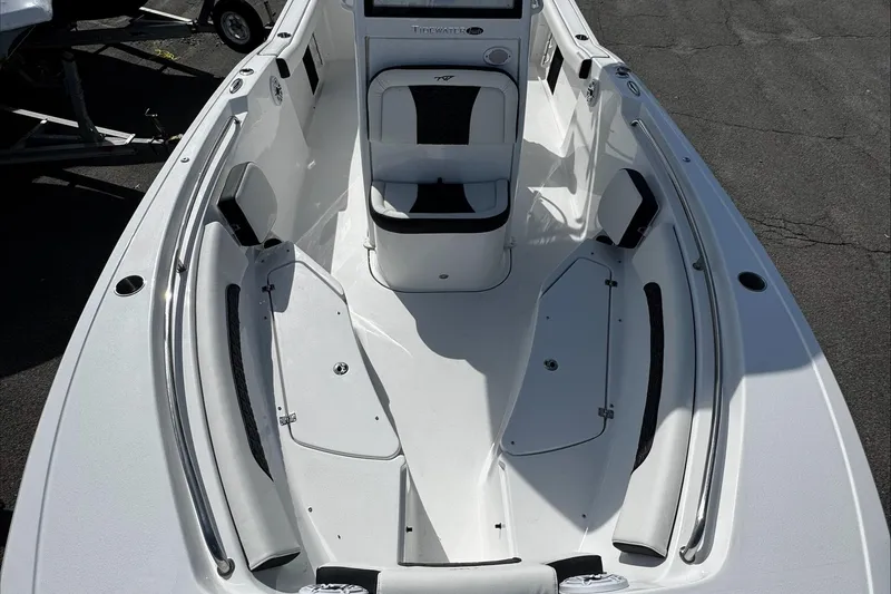 Slide: The Image of 2025 Tidewater 232 CC Adventure boat interior with seating and storage compartments. - 27