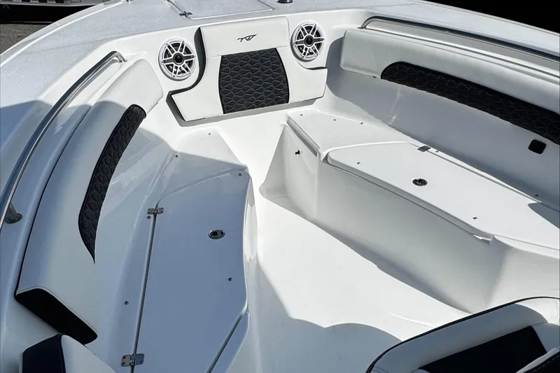 Slide: The Image of 2025 Tidewater 232 CC Adventure boat interior with seating and speakers. - 30