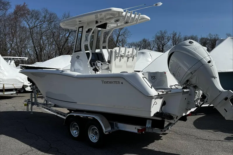 Slide: The Image of 2025 Tidewater 232 CC Adventure boat on trailer, featuring sleek design and powerful outboard motor. - 4
