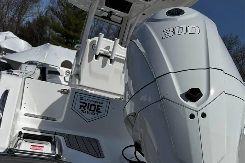 Slide: The Image of 2025 Tidewater 232 CC Adventure boat with powerful 300 engine, featuring SeaKeeper Ride stabilization. - 5