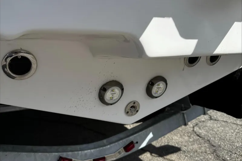 Slide: The Image of 2025 Tidewater 232 CC Adventure boat hull with underwater lights and fittings. - 8