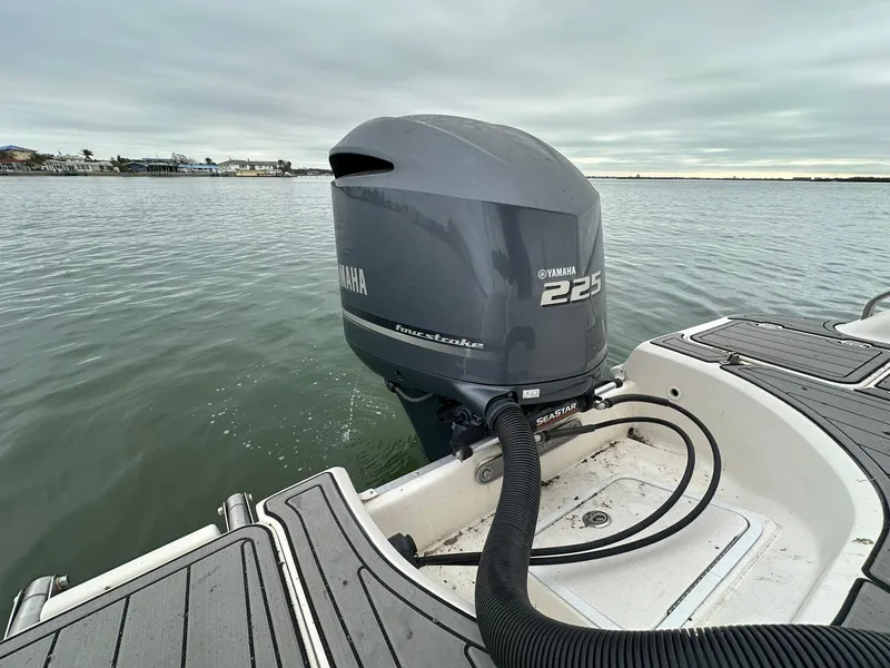 Slide: The Image of 2007 Hurricane SunDeck 237 OB with Yamaha 225 outboard motor on calm water. - 10