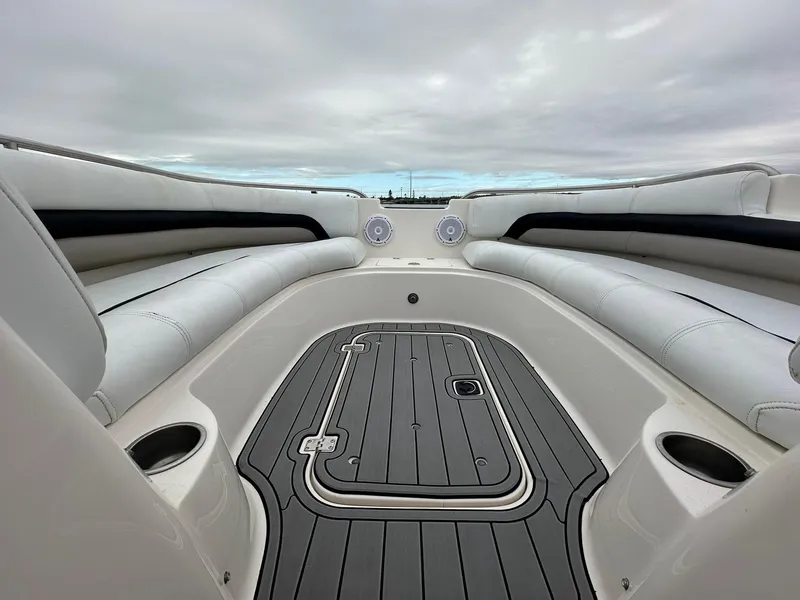 Slide: The Image of 2007 Hurricane SunDeck 237 OB boat interior with cushioned seating and deck. - 2