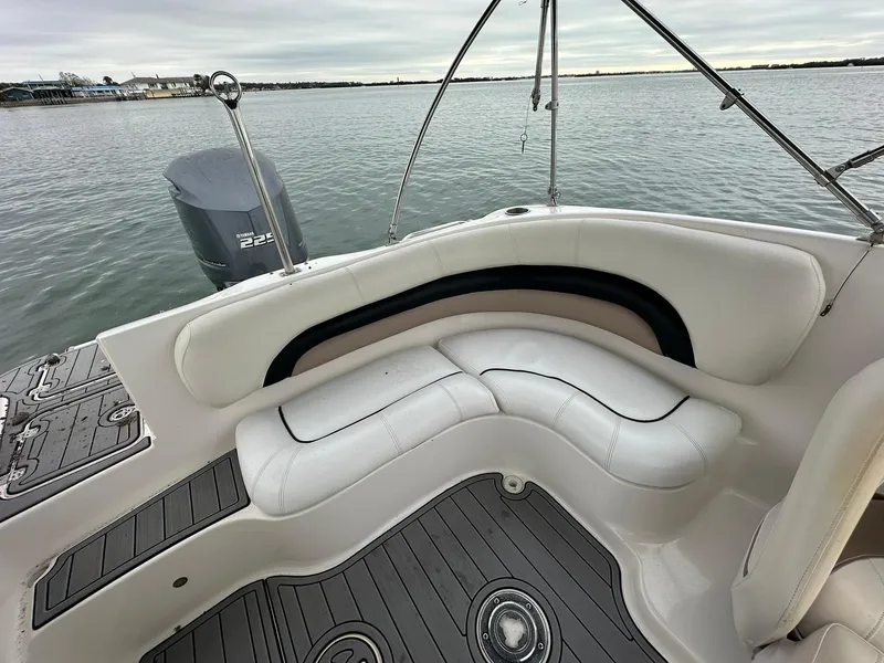 Slide: The Image of 2007 Hurricane SunDeck 237 OB boat interior with white seating and water view. - 6