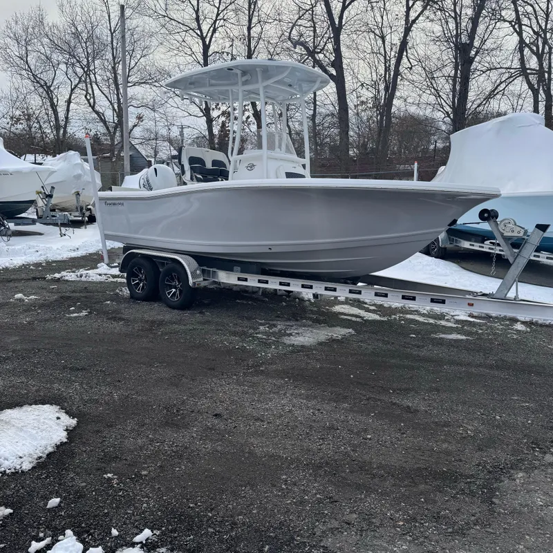 Slide: The Image of 2025 Tidewater 198 CC Adventure boat on trailer in snowy outdoor setting. - 1