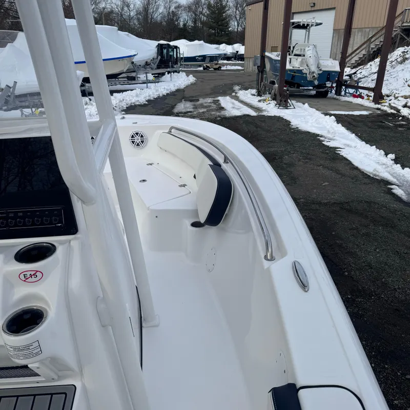 Slide: The Image of 2025 Tidewater 198 CC Adventure boat interior with seating, parked outdoors in snowy setting. - 13