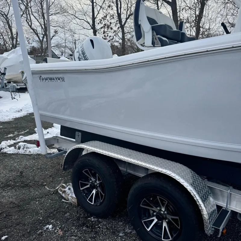 Slide: The Image of 2025 Tidewater 198 CC Adventure boat on trailer in snowy outdoor setting. - 2